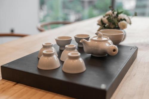 a tray with tea pots and cups on a table at Nine Tree by Parnas Seoul Insadong in Seoul