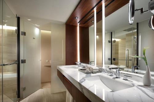 
a bathroom with two sinks and a large mirror at The Shilla Seoul in Seoul
