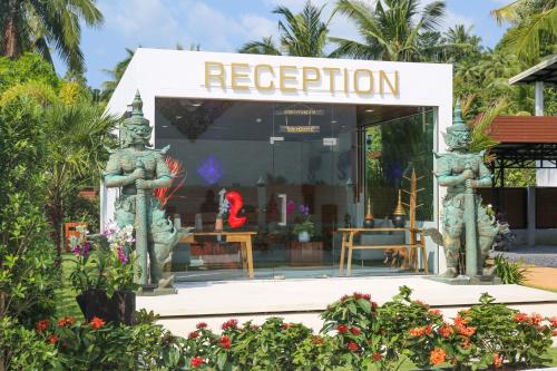 a shop with two statues in front of it at Zee Luxury Boutique Hotel in Hinkong