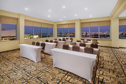 a conference room with chairs and tables and windows at Holiday Inn Hotel Port of Miami-Downtown by IHG in Miami