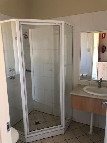 a bathroom with a shower and a sink at Collie Ridge Resort in Collie