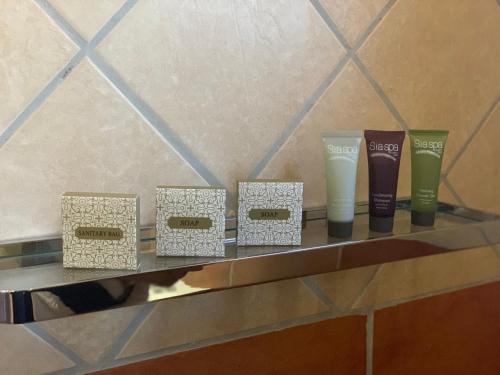 a group of four vases and boxes on a counter at Polokwane Lodge in Polokwane
