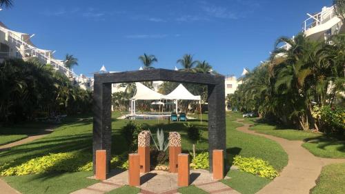 a stone arch in the middle of a park at Renta de departamento en Acapulco Diamante in Acapulco
