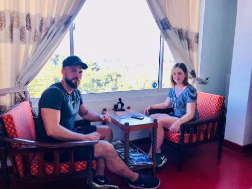 a man and a woman sitting at a table at 47 Alfred House - Free Pickup from Kandy City in Kandy