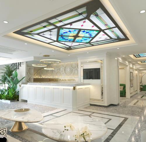 a hotel lobby with a stained glass ceiling at Ganjali Plaza Hotel in Baku