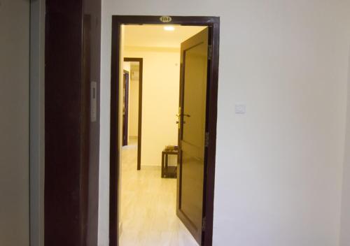 an open door to a hallway with a mirror at Cloud Nine Serviced Apartments in Chennai