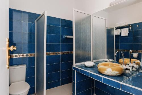 a blue bathroom with a sink and a toilet at Desert Moon in Cairo