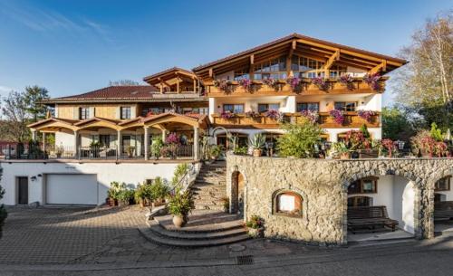 a large house with a balcony on top of it at Landgasthaus & Hotel Kurfer Hof in Bad Endorf