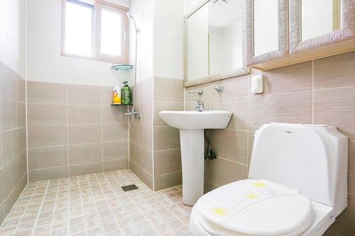 a bathroom with a toilet and a sink at Jeju Special Pension in Jeju