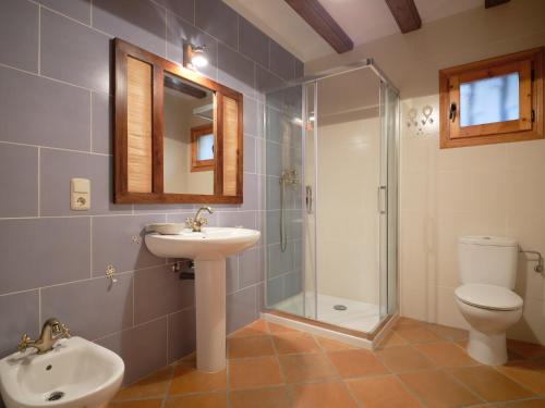 a bathroom with a sink and a toilet and a shower at Casa del Moliner in Boada