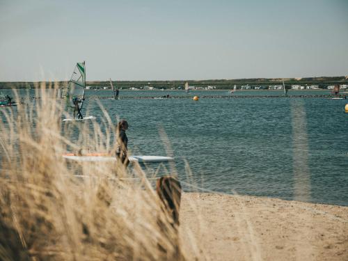 a view of a beach with a body of water at Ridderstee Ouddorp Duin in Ouddorp