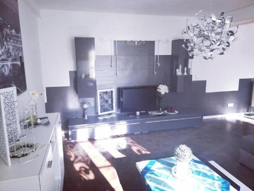 a living room with a table and a chandelier at Ferienwohnung auf der Hilkenhöhe in Iserlohn