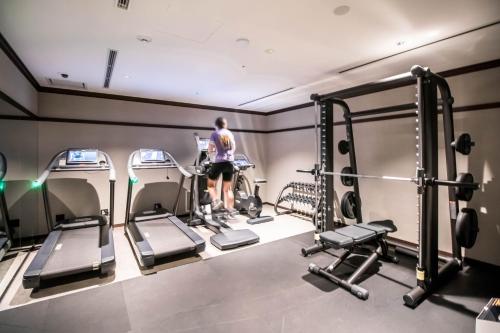 a man standing in a gym with several tread machines at Dhawa Yura Kyoto in Kyoto