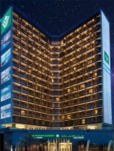 a rendering of the magellan casino hotel at night at Wyndham Garden Ajman Corniche in Ajman 