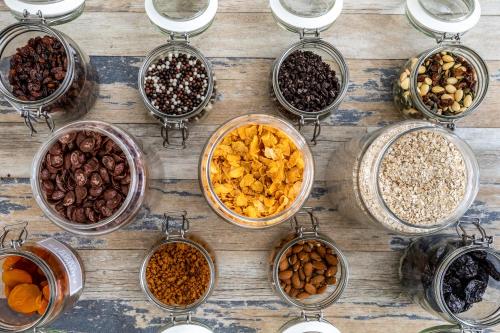 a table with many bowls of different types of nuts at ibis Styles Sceaux Paris Sud in Sceaux