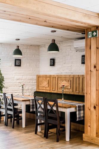 a dining room with wooden tables and chairs at Hotel Helios 300m od Krupówek nowy BASEN od 12 lipca in Zakopane