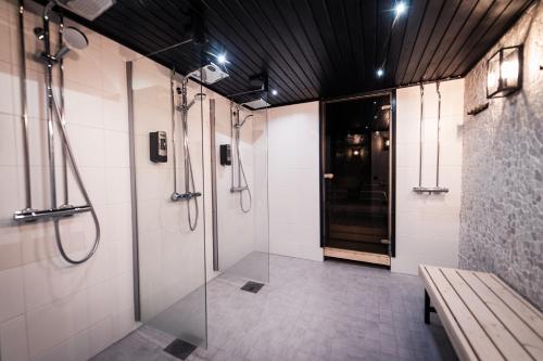 
a bathroom with a shower and a walk in shower at Hotel Aakenus in Rovaniemi
