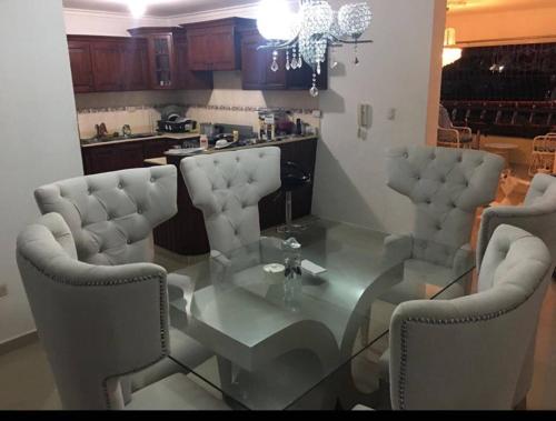 a dining room with a glass table and chairs at Total New!! Exclusive!! Apt At Paradise V .. in Santo Domingo