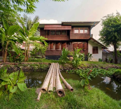 a house with a bunch of logs in front of it at Yesterday Sathon in Bangkok