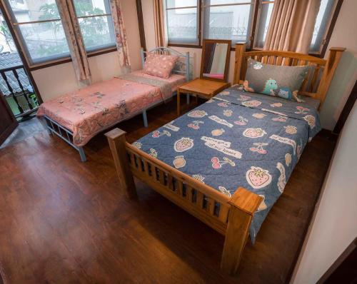 a room with a bed and a bench and windows at Yesterday Sathon in Bangkok