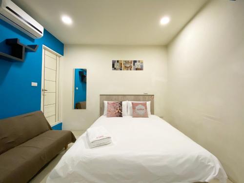 a small bedroom with a bed and a couch at Day Day Fengjia in Taichung