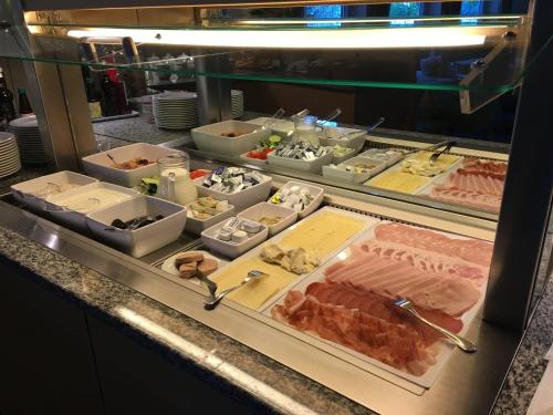 a buffet line with different types of food on display at Hotel Neuhausmühle in Vilpiano