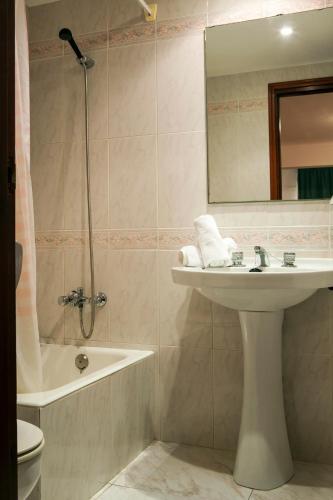 a bathroom with a sink and a shower with a mirror at Apartamentos Maria - Formentera Vacaciones in Es Pujols