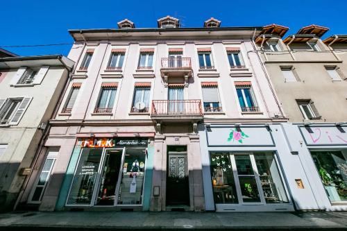 a large white building with a store front at le cocon voironnais in Rives