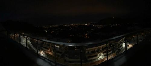 a building at night with a view of a city at Seasons-Top of the city in Braşov