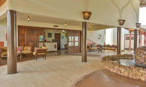 a large living room with a fountain in the middle at Kena Beach Hotel in Matemwe