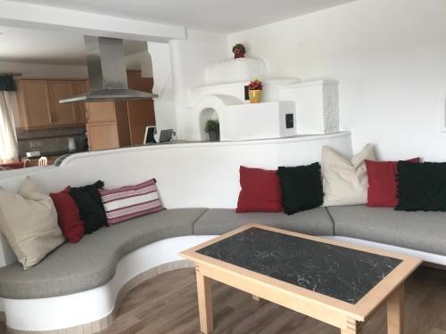 a living room with a couch and a coffee table at Haus Bayliss in Zederhaus