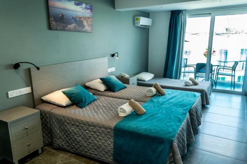 Ένα ή περισσότερα κρεβάτια σε δωμάτιο στο A.Maos Hotel Apartments 