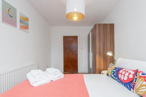 a bedroom with a bed with towels on it at WelcomeStay Clapham Junction 2 Bedroom Apartment in London