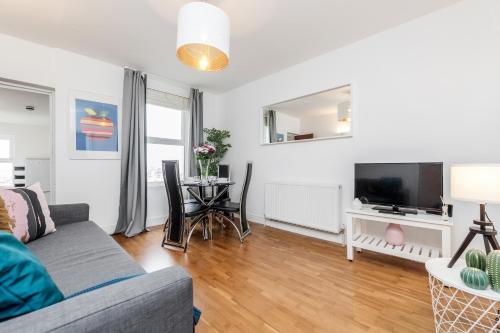 a living room with a couch and a table at WelcomeStay Clapham Junction 2 Bedroom Apartment in London