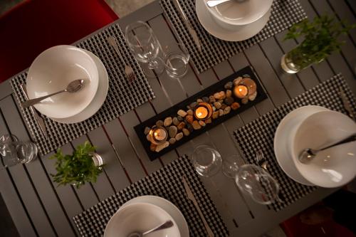 a table with plates and wine glasses on it at Kruger Cliffs Lodge - Absolute privacy guaranteed in Hoedspruit