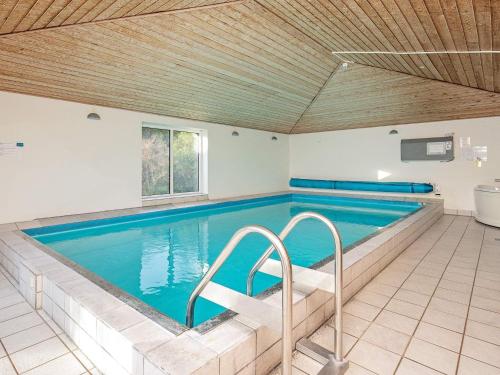 a large swimming pool with blue water at 16 person holiday home in Vestervig in Vestervig