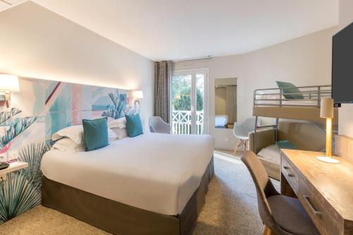 a hotel room with a bed and a bunk bed at Best Western Plus Hyères Côte D'Azur in Hyères