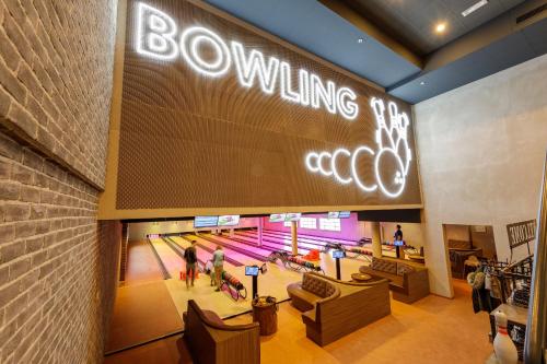 a bowling alley with a large sign on the wall at Hotel Hochsauerland by Center Parcs in Medebach