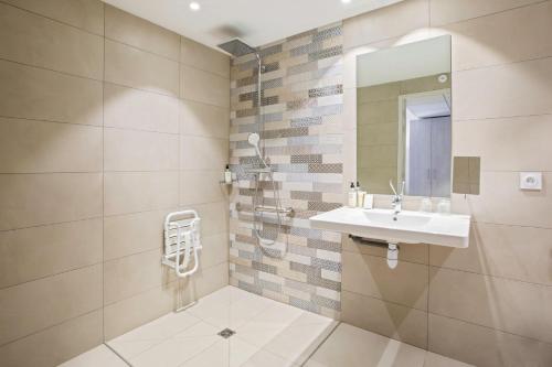 a bathroom with a sink and a mirror at Best Western Plus Hyères Côte D'Azur in Hyères