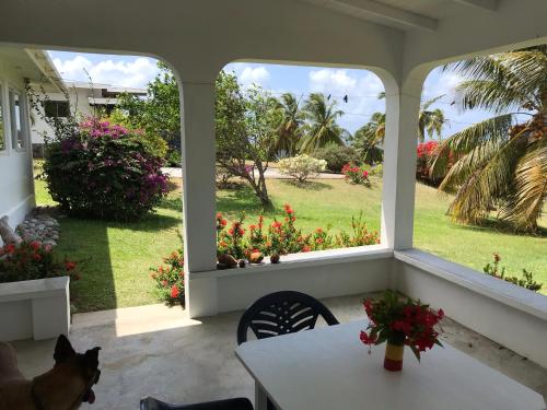 a room with a table and a view of a garden at Romantic Cottage in Sauteurs