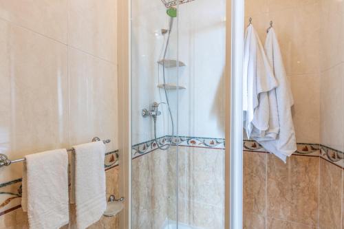 a bathroom with a shower with a glass door at B&B La Riviera in Gallipoli