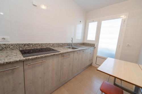 a kitchen with a sink and a counter top at HomeHolidaysRentals Bonte in Malgrat de Mar