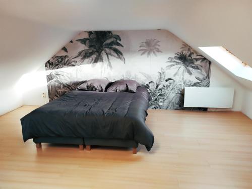 a bedroom with a bed with palm trees mural at Maison familiale tout confort avec garage in Lompret
