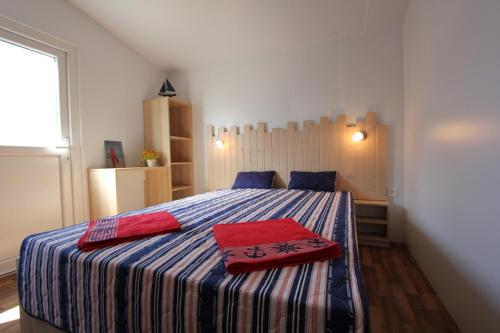 - une chambre avec un lit doté de 2 oreillers rouges dans l'établissement Mobile home type A and B, à Premantura