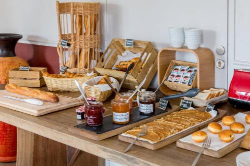 a table with bread and other food items on it at Best Western Plus Hyères Côte D'Azur in Hyères