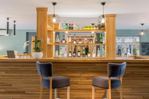 a bar with two chairs in front of it at Best Western Plus Hyères Côte D'Azur in Hyères