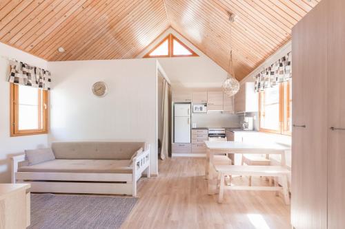 a living room with a couch and a table at Yyteri Holiday Cottages in Pori