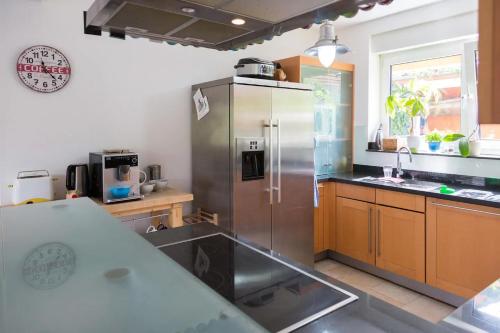 a kitchen with a large stainless steel refrigerator at Schönste Lage am Rhein in unmittelbarer Stadtnähe, B & B in Cologne