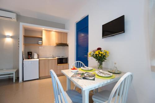 a kitchen and dining room with a table and chairs at Anna Plakias Apartments in Plakias