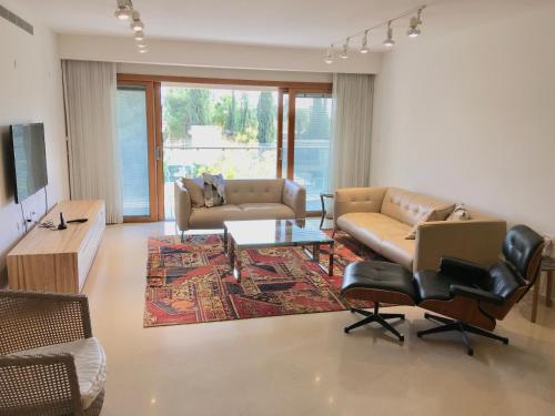 a living room with a couch and chairs and a table at JERUSALEM KING DAVID in Jerusalem